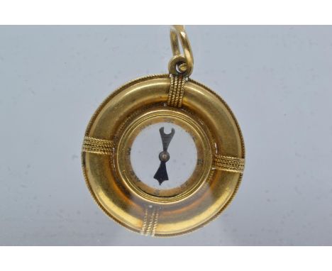 Yellow metal compass charm pendant, tests positive for 9ct gold, 25mm diameter, gross weight 6.38 grams 