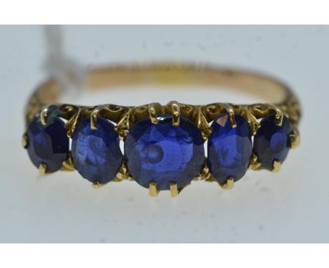 Yellow metal & five stone sapphire ring, tests positive for 18ct gold, size N, 2.87 grams 