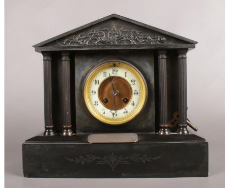 A Black Slate Mantle Clock with Metal Columns depicting a classical battle scene. Silver Presentation Plaque on the front ass