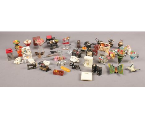 A tin of vintage fridge magnets. Including kitchen scales, pram, stove, mangle, etc.  