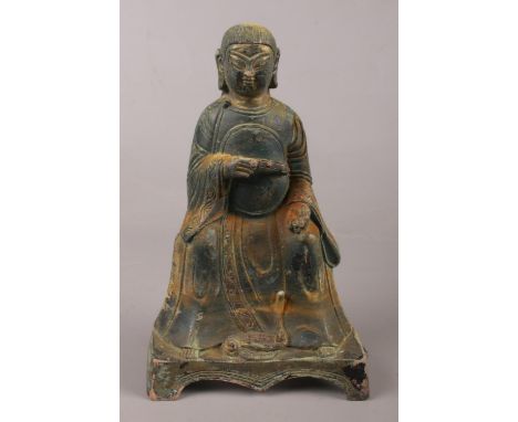 A Sino Tibetan bronze buddha with a snake at his feet. 24cm.  