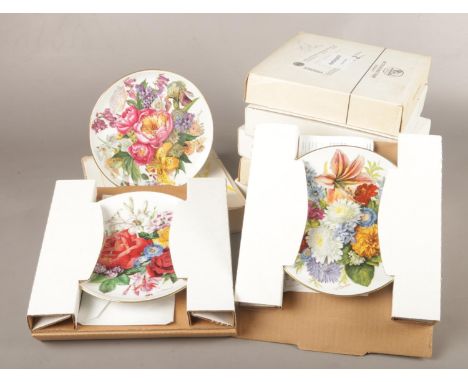 A group of eight boxed German ceramic wall plates made by Hutschenreuther and painted by Ursula Band. Certificates included. 