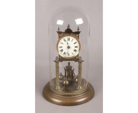 A Perpetual Motion Brass Mantle Clock with Glass Dome.  Condition Fair, in need of attention.