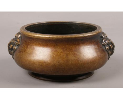 A Japanese bronze censor with dragon mask decoration. Character marks to the base. H:8cm, W:17cm.  
