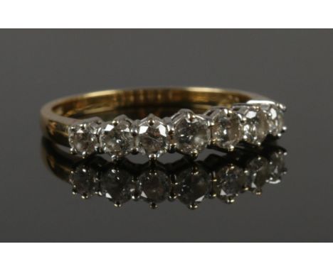 An 18ct gold and diamond seven stone ring. (1ct of diamonds). Size R 1/2. 3.67g.  