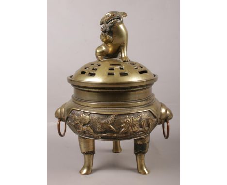 A Chinese bronze lidded censor. Temple lion finial and character marks to base.  