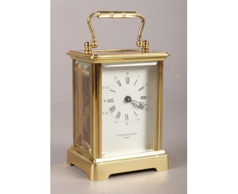A Taylor &amp; Bligh of London brass carriage clock. Comprising of an enamel dial with Roman and Arabic numerals. H:15cm, W:8