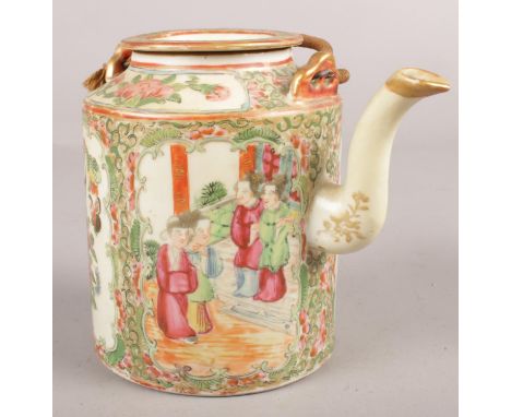 A Cantonese ceramic teapot decorated with figures and flowers.  