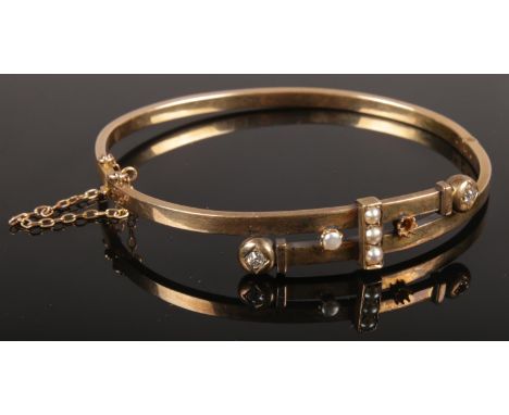 A 15ct gold diamond and pearl bangle. 9.38g.  