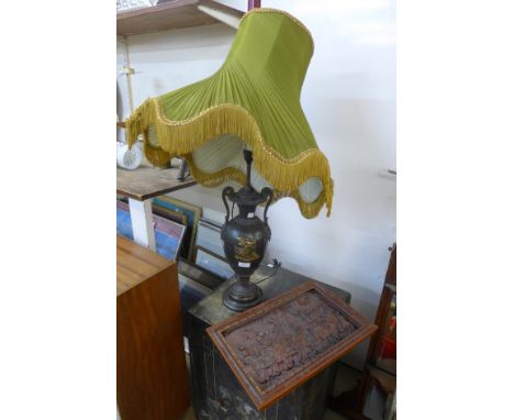 A Greek style table lamp and a carved oak plaque, depicting knights on horseback