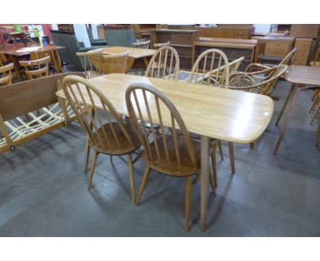 An Ercol Blonde elm and beech plank dining table and four Quaker chairs 