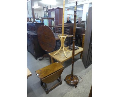 An oak drop-leaf occasional table and a standard lamp 