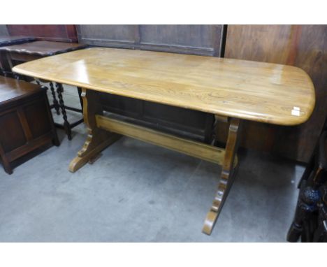 An Ercol Golden Dawn elm refectory table 