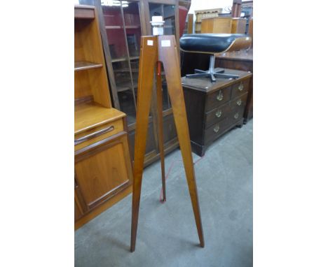 A teak tripod standard lamp 