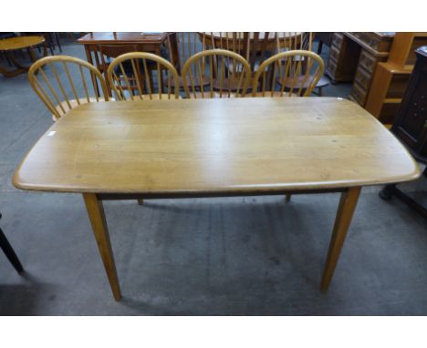 An Ercol Golden Dawn elm and beech plank dining table 