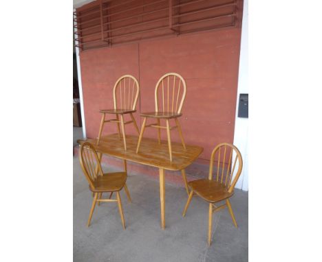 An Ercol Blonde elm and beech plank dining table and four Windsor chairs 