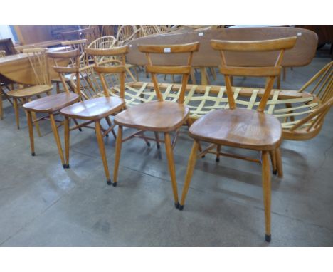 A set of four Ercol green dot beech stacking chairs 