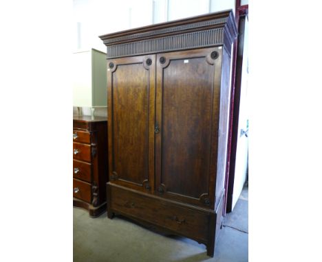 A Chippendale Revival carved mahogany fitted two door wardrobe 