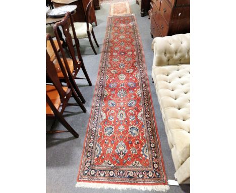 An Indian Persian pattern runner, a patterned red field, narrow borders, 430cm x 80cm; and a machine-made rug.