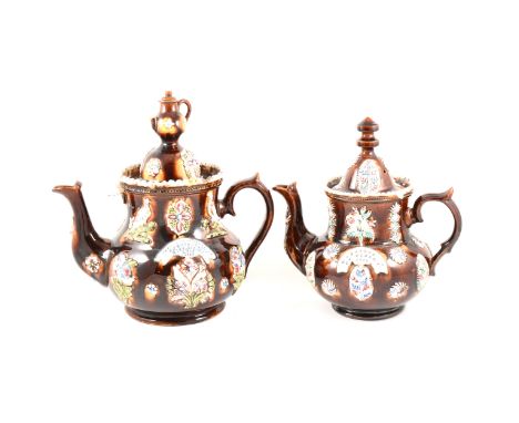 A Victorian bargeware teapot W. BARNES, GT. GLENN, 1882, hard moulded decoration, treacle glazed, 32cm; and another bargeware