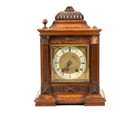 An oak cased mantel clock, silvered chapter ring, movement striking on two gongs, 39cm.