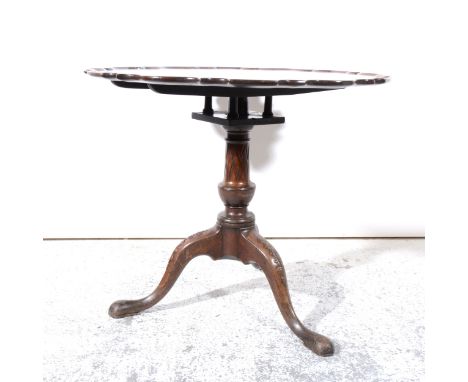 A George III mahogany pedestal table, shaped and moulded piecrust edge, birdcage under-section, baluster column, tripod legs 