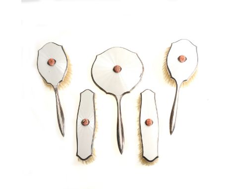 A five piece silver and white enamel dressing table set by Asprey &amp; Co Ltd, marcasite and coral-coloured centre decoratio