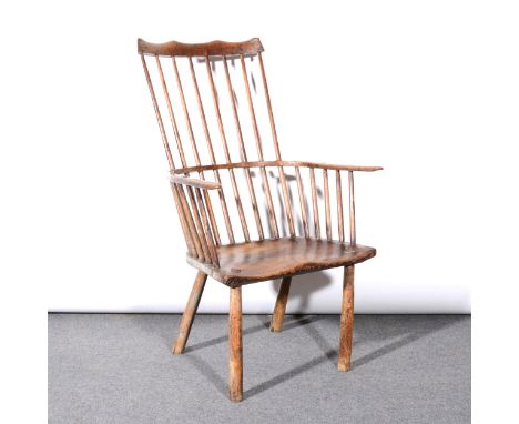 Primitive elm and ash comb-back Windsor chair, probably West Country, 18th Century, with traces of old paintwork, shaped comb