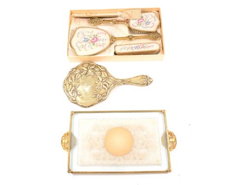 A boxed dressing table set by Rondis, comprising a hair brush, hand brush, comb, mirror with floral design and filigree handl