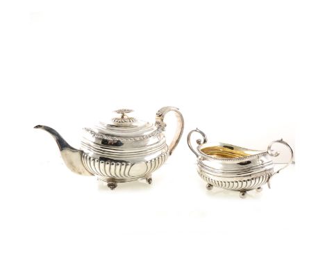 A George III silver teapot by Thomas Wilkes Barker, London 1819, semi fluted, gadrooned and shell cast rim, leaf-capped reede