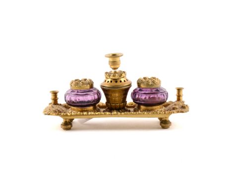 French gilt metal desk stand, fitted with two amethyst coloured glass inkwells, cast fruit and vine outlines, width 20cm.