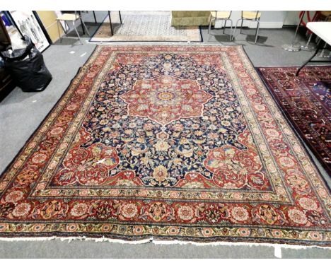 A Tabriz pattern carpet, central medallion, floral pattern blue ground field, border within guards, 400cm x 300cm.