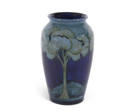 A tall Moorcroft vase c.1925 decorated with the Moonlit blue landscape pattern impressed factory mark and signature in green 