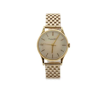 An 18ct gold IWC gents wristwatch on a yellow metal bracelet which is stamped on the clasp 9ct, the watch has a manually crow