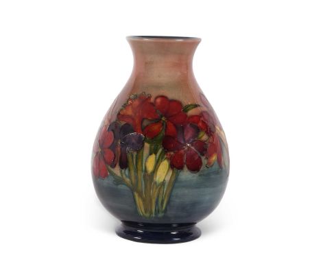 A mid 20th century Moorcroft vase of baluster shape decorated with the Spring Flowers pattern in a flambe type glaze impresse