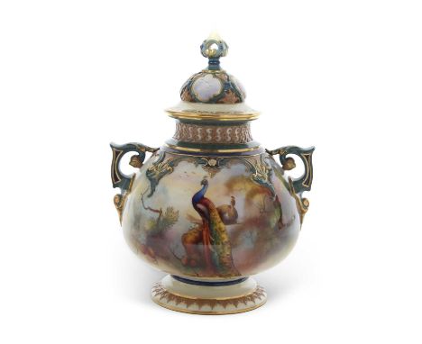 A impressive Hadley Worcester style vase and cover with green handles picked out in a gilt design, decorated with peacocks, s