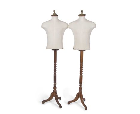 A pair of early 20th Century shop display mannequins by Harris &amp; Sheldon set on turned wooden supports with tripod bases,