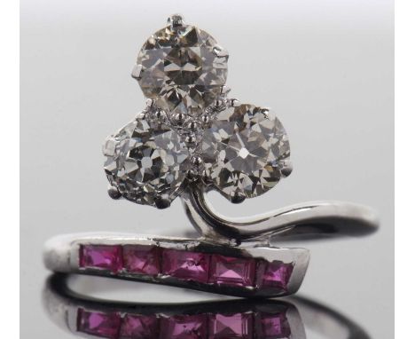 A diamond and ruby ring, the trefoil set three old brilliant cut diamonds, total carat weight estimated approx. 1.5cts, with 