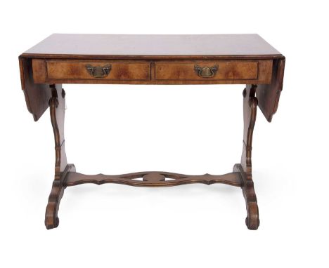 A Georgian style mahogany two drawer sofa table with drop leaves, shaped end supports and a pierced central stretcher support