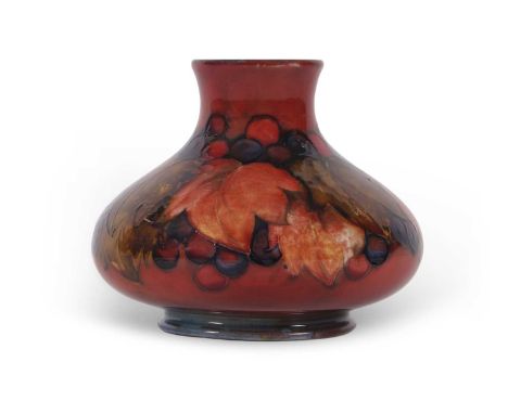 A Moorcroft vase of compressed ovoid form in the leaf and berry pattern with a flambe glaze impressed factory mark and signat