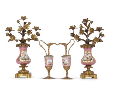 A pair of 19th century Sevres style candelabra the pink ground with gilded panels painted with birds with ormolu mounts toget