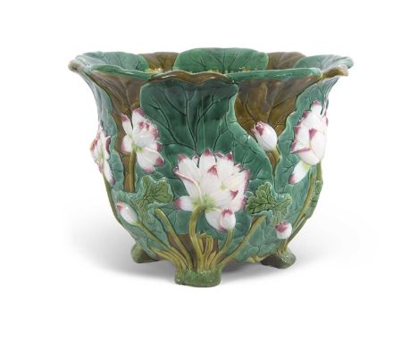A very large 19th Century Minton Maiolica jardiniere raised on four stub feet, the green leaf ground decorated in relief with