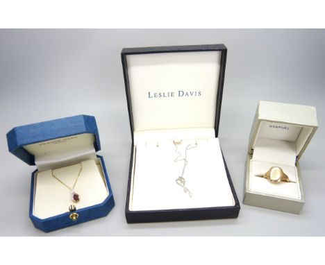 Two 9ct gold pendants on 9ct gold chains and a 9ct gold ring (4g). Q