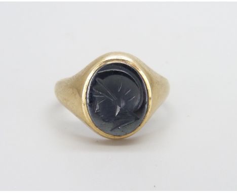 A 9ct yellow gold and carved hematite intaglio ring (4.3g). M