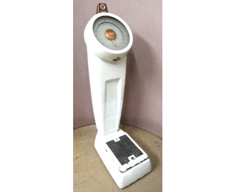 A set of vintage Avery floor standing platform scales with a penny slot
