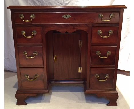 A George III magogany desk raised on ogee bracket feet, 78cm wide by 45cm deep.   