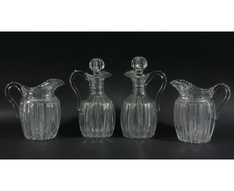 PAIR OF ENGLISH GLASS HANDLED DECANTERS AND STOPPERS, circa 1800, of ovoid form decorated with alternating clear and strawber