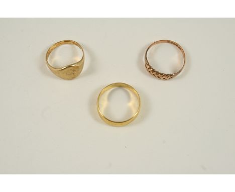 A GOLD SIGNET RING size K 1/2, together with two other gold rings, total weight 7.7 grams.