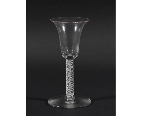 GEORGE III WINE GLASS, the bell shaped bowl on a stem with a central white enamel gauze inside a multi-strand helix, on a spr