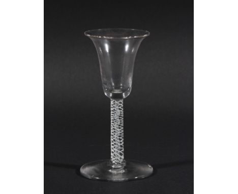 GEORGE III WINE GLASS, the bell shaped bowl on a stem with a central white enamel gauze inside a multi-strand helix, on a spr